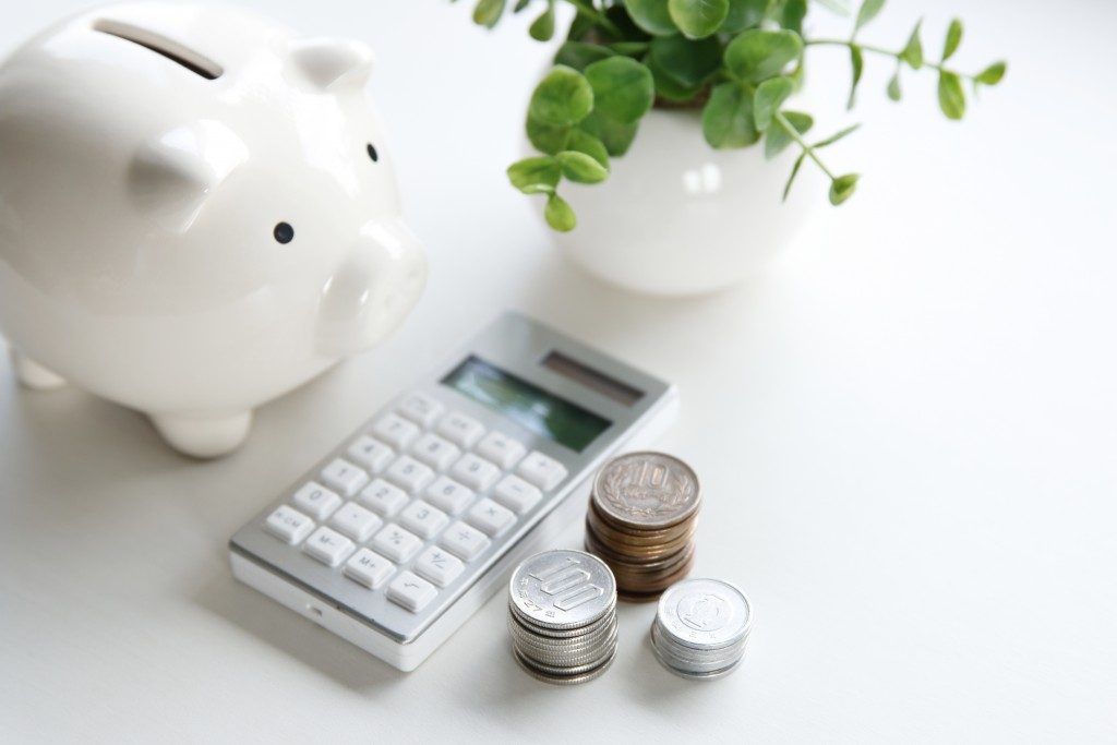 coins, calculator, and piggy bank