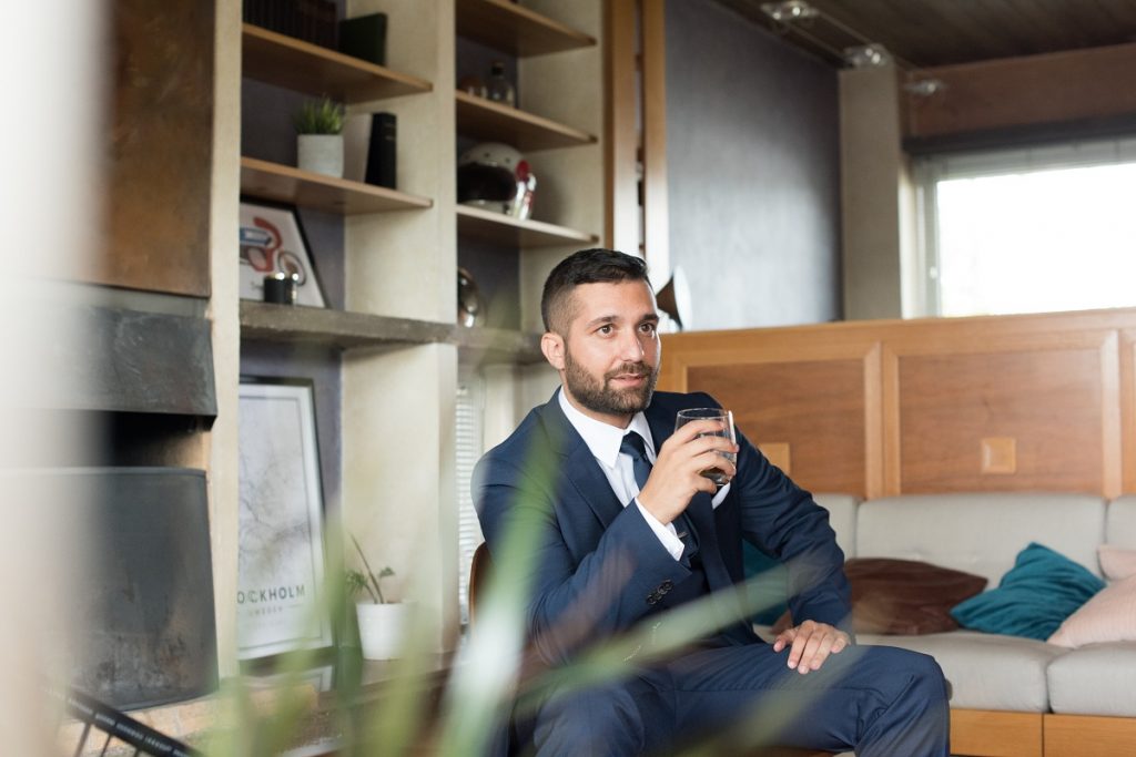 Man in corporate attire holding a cup of coffee