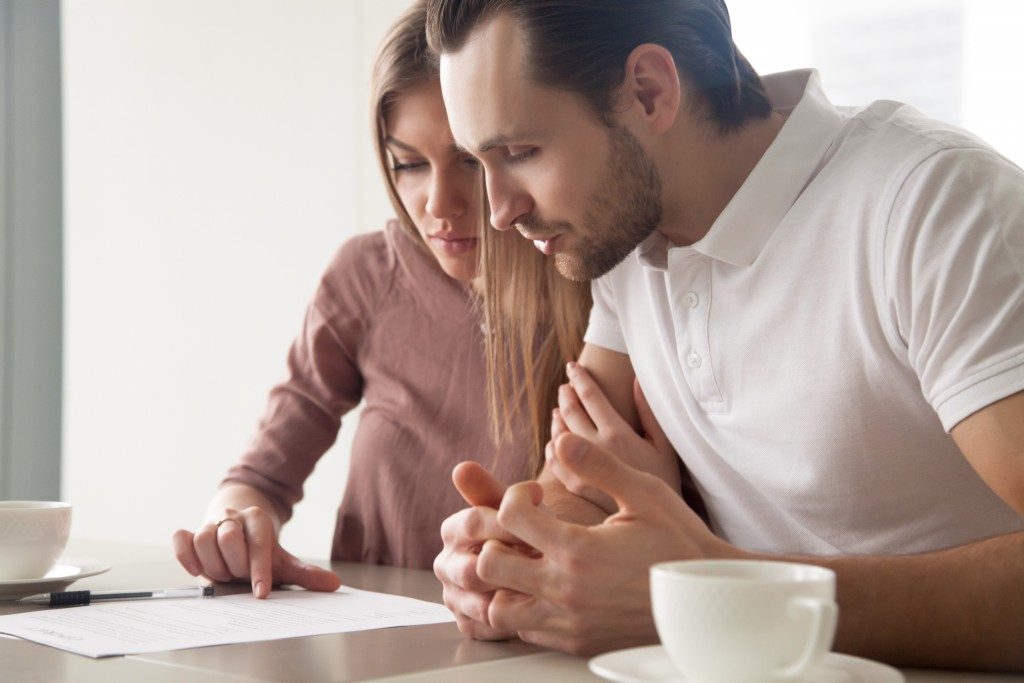 Couple reading through a mortgage form