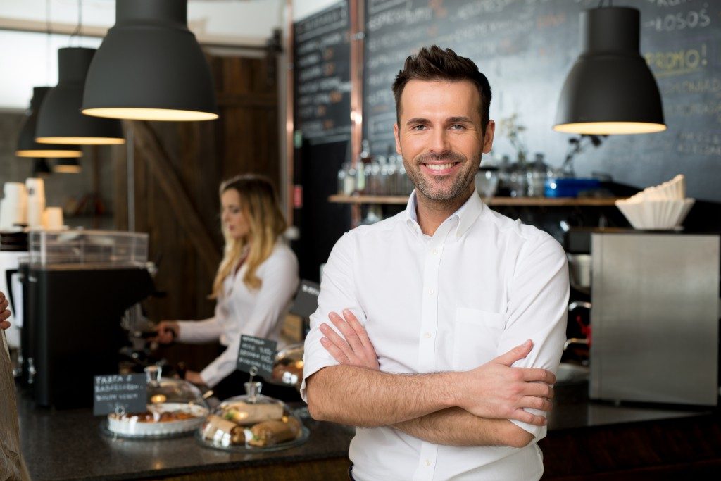 restaurant owner standing in front of the counter