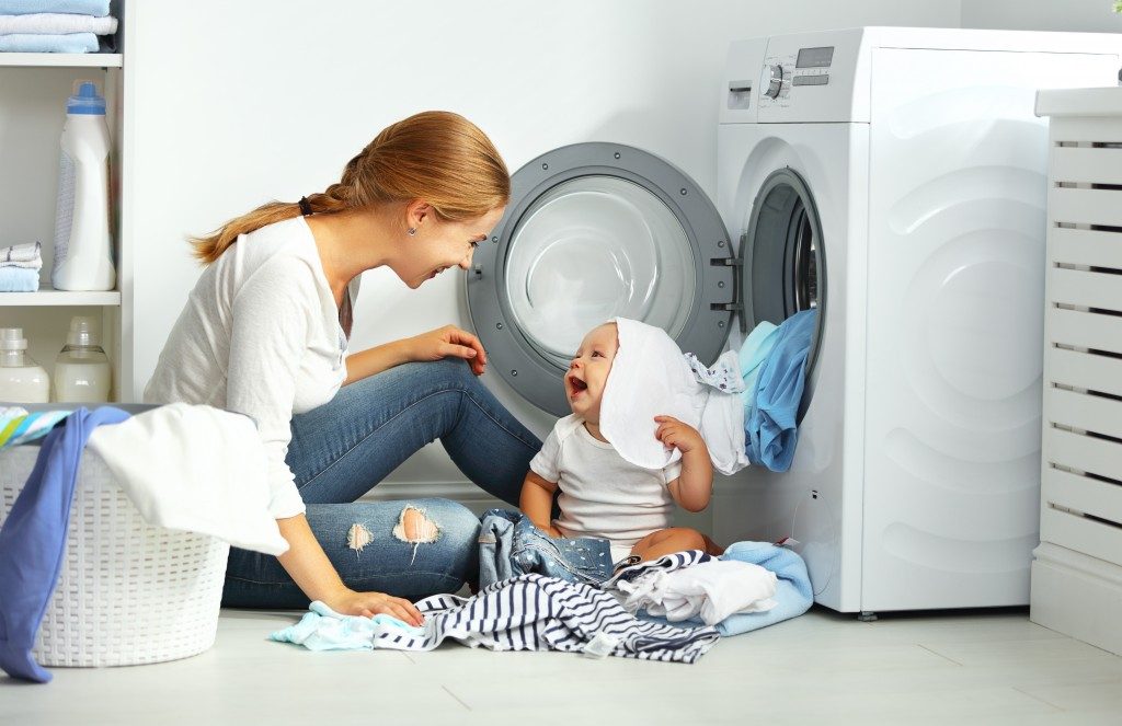 Mother and toddler laundry