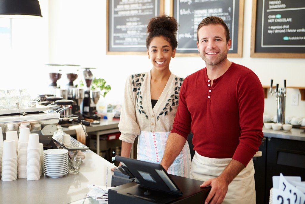 employee and employer standing in front of the counter