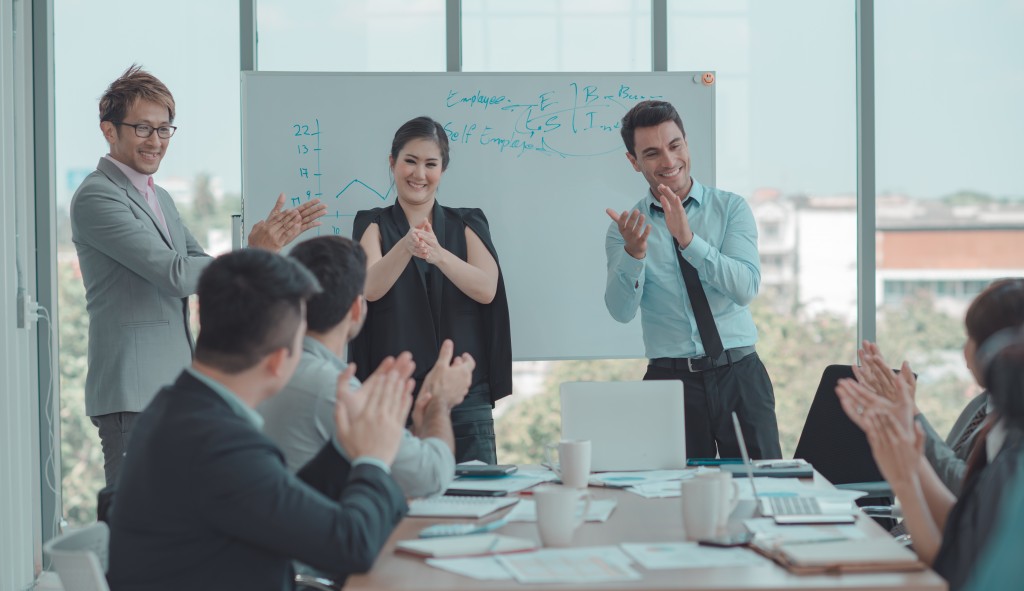 people clapping their hands at a meeting