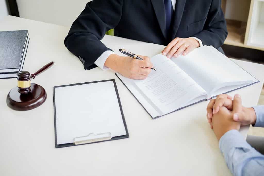 lawyer writing infront of client