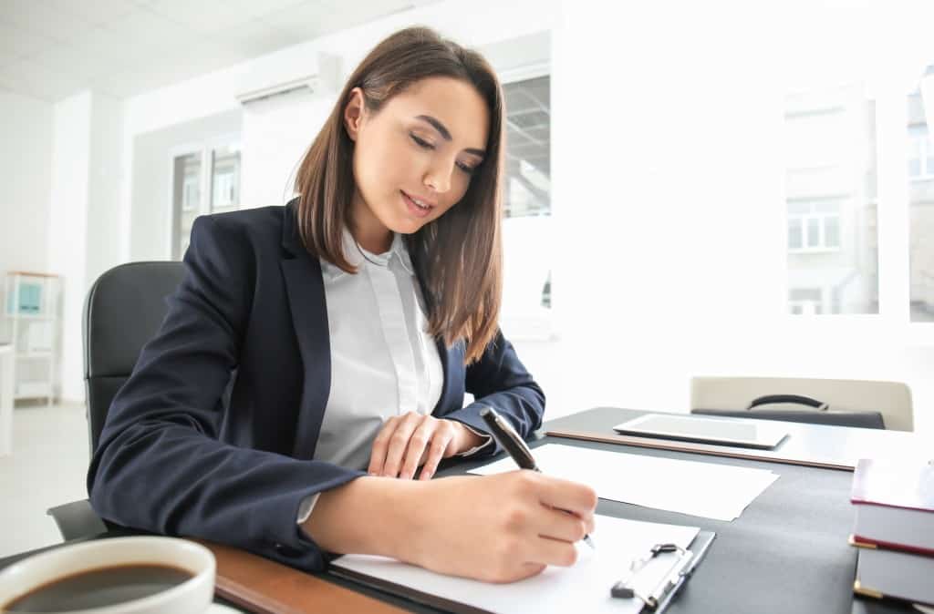 woman writing on paper