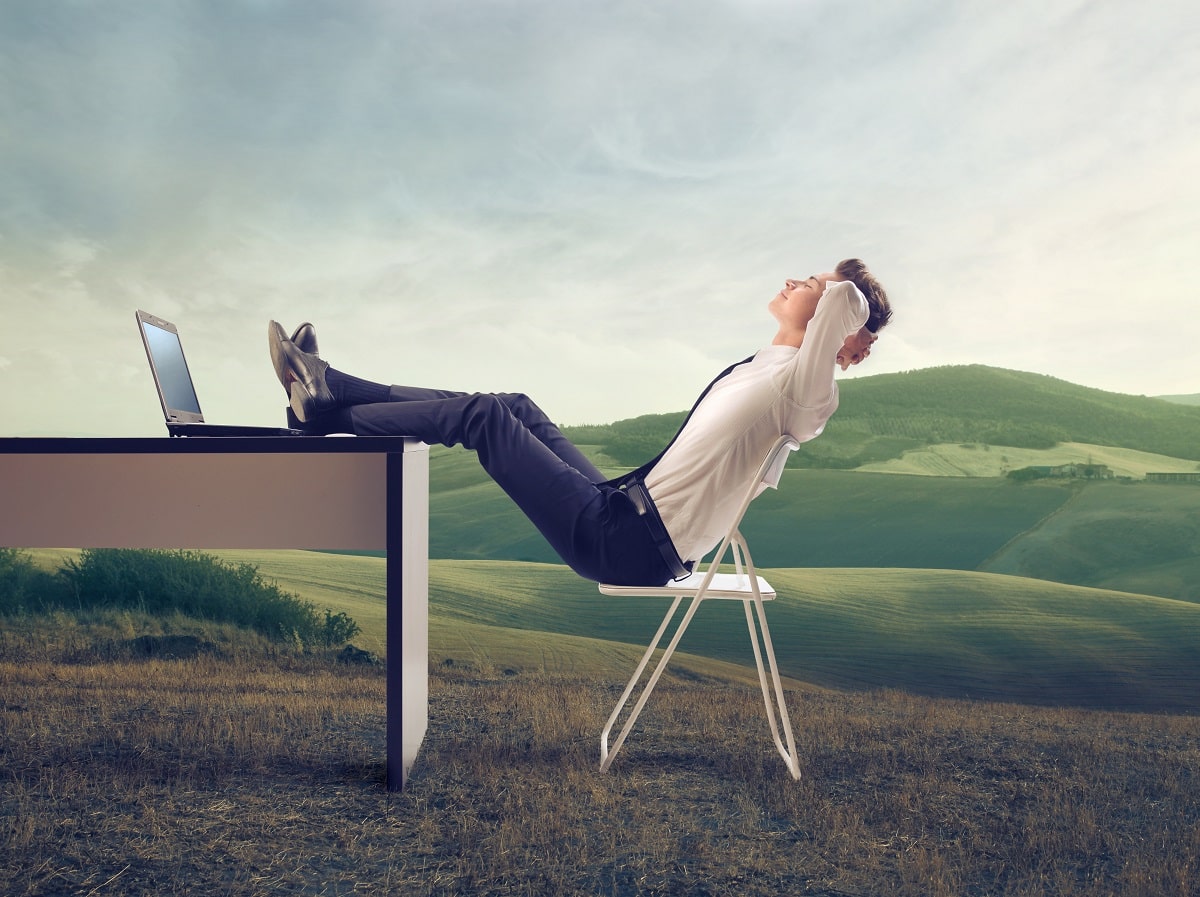 Guy thinking in front of laptop while looking at the sky