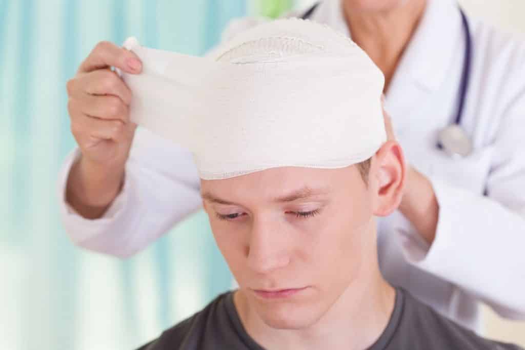 man with bandage around the head