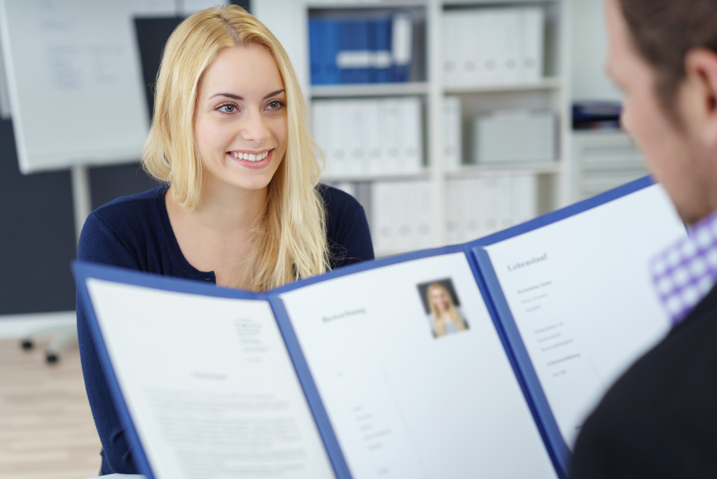 a businessman holding an applicant resume in an interview