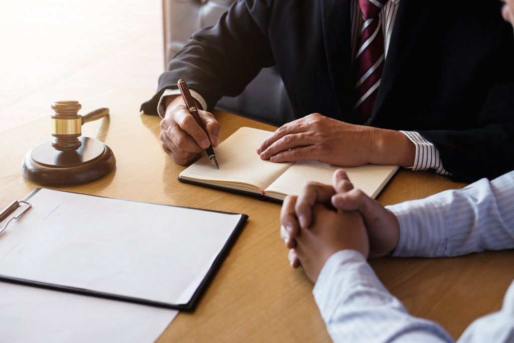 Focus on man's hands as he talks to lawyer