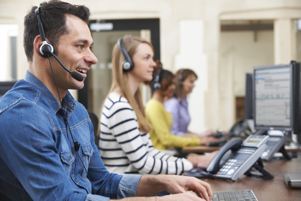 a man wearing a headphone and providing tech support