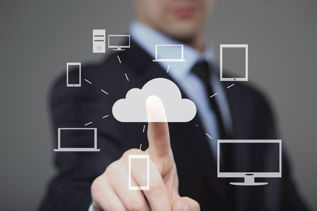 businessman pointing at a cloud software
