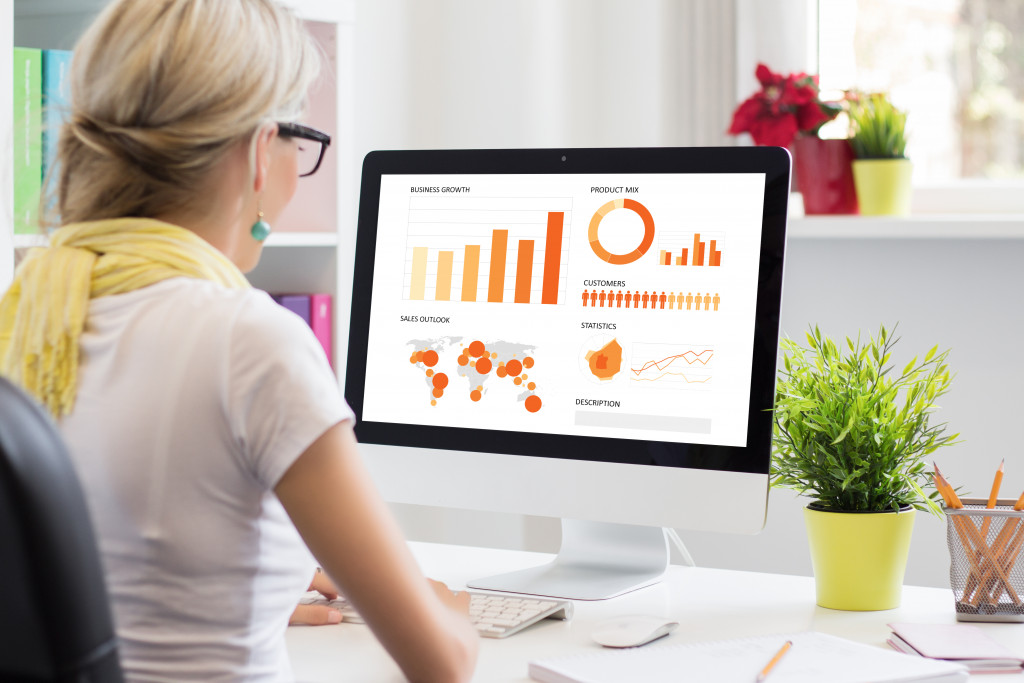 a businesswoman using a computer to check business charts