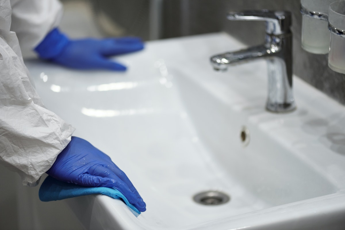 worker cleaning sink