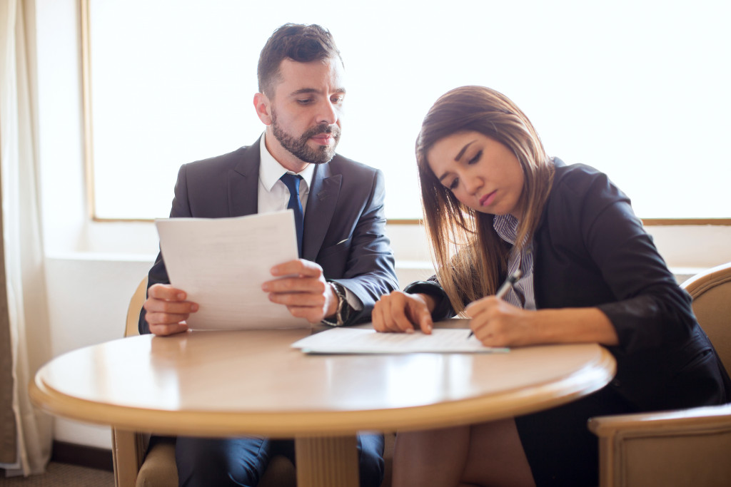 Business executives checking expenses to prioritize essential expenses.