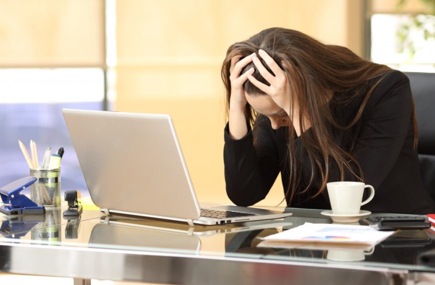 A depressed woman working in an office